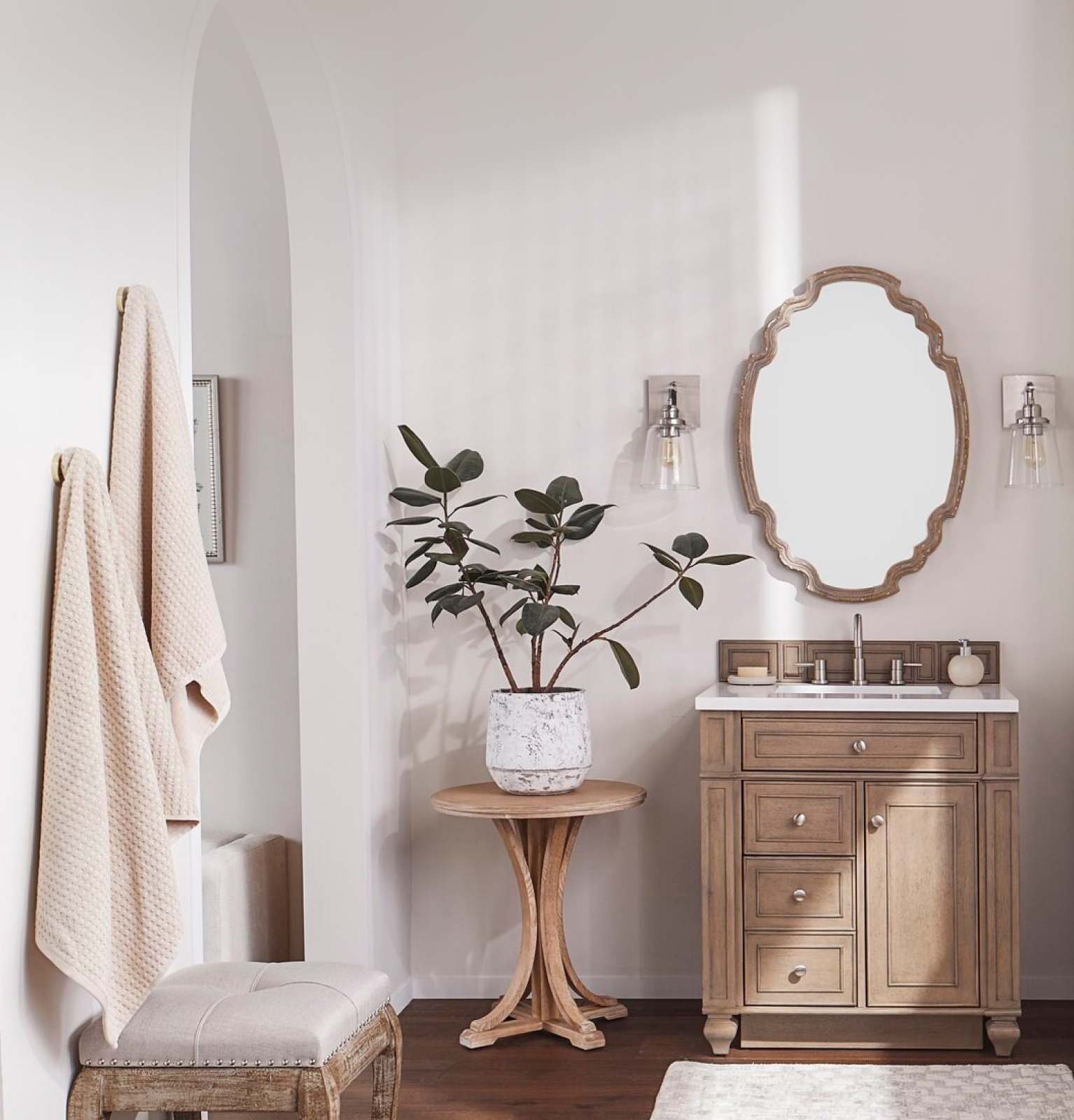 a sunny bathroom with a wood vanity and a light bath mat available online at Overstock