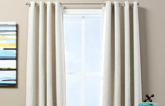 Cream blackout window curtains.