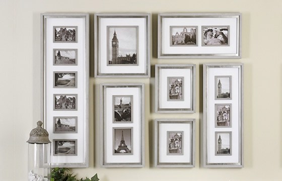 An assortment of picture frames hung on a wall to create a gallery wall.