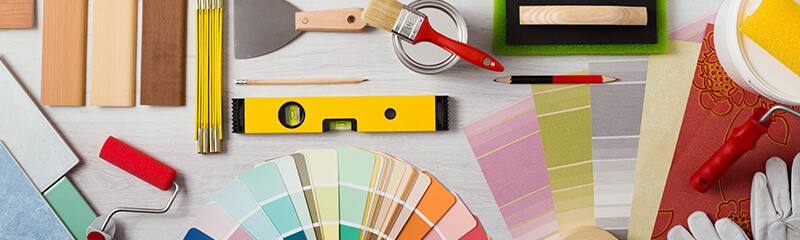 Tools to update your space; paint swatches, flooring samples, and paint brushes. 