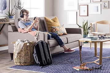 Living room with area rug and boy playing