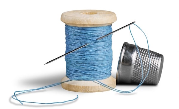 Image of needle, thread and thimble