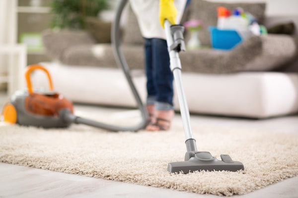 Woman Vacuuming a Carpet