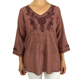 Handmade cotton blouse with floral hand-embroidered details. Produced by traditional artisans in Oaxaca, Mexico. Fairly traded.