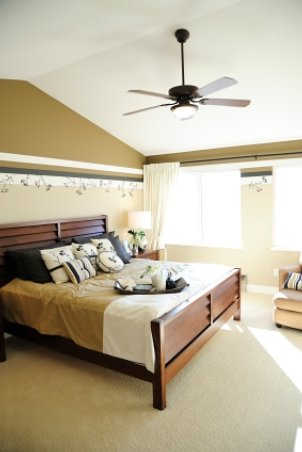 Lighted ceiling fan cools bedroom