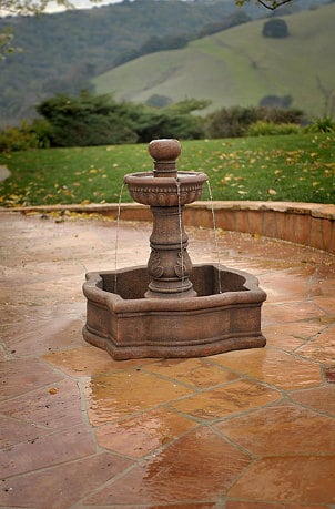 Rustic outdoor fountain complements stone patio