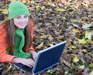 Female student outdoors with a notebook computer