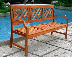 Wooden bench by an outdoor pool