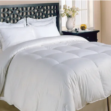 White comforter set on dark bed