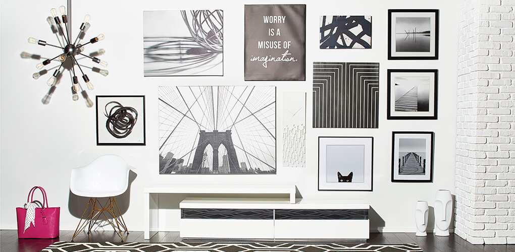 Bright white modern art wall featuring black and white photography, and geometric wall art 