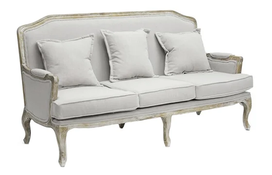 An antiqued style loveseat with linen cushions 