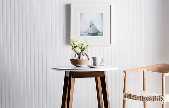 Beadboard wall with small table and chair