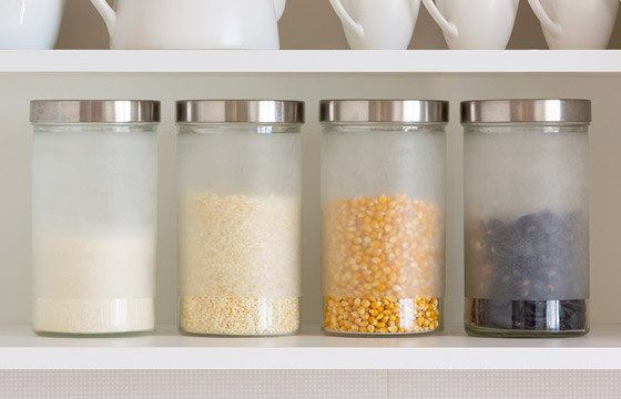 Four glass canisters filled with grains