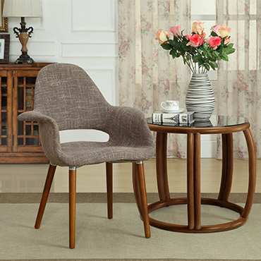 Light gray organic style dining arm chair next to end table