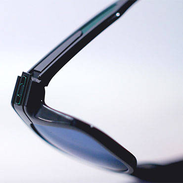 A pair of black Oakley sunglasses bending at the hinges