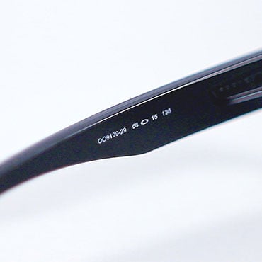 A close up shot of a SKU on the inside of a pair of Oakley sunglasses
