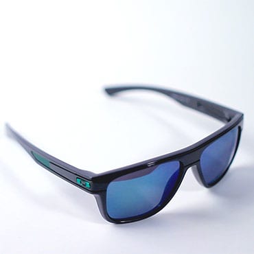 A pair of black Oakley sunglasses with blue polarized lenses