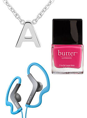 Teen girl opening gift with stocking ideas featuring headphones, monogrammed necklace, and nail polish