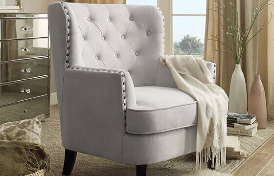 Tufted upholstered armchair with nailhead trim