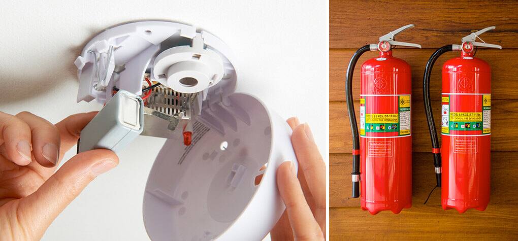 A person changing out batteries in a smoke detector and  two fire extinguishers next to each other