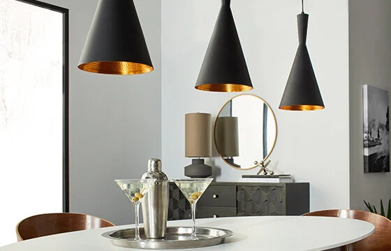 Three modern matte black pendant lights with gold on the inside 