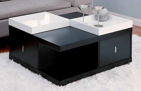 A black modern coffee table with two white trays on top