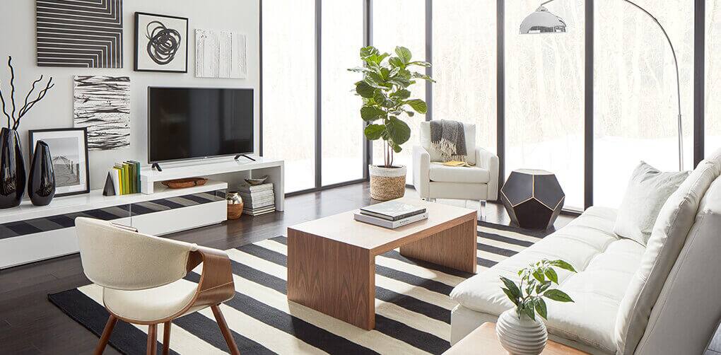 A beautiful modern living room with hues of black and white furniture