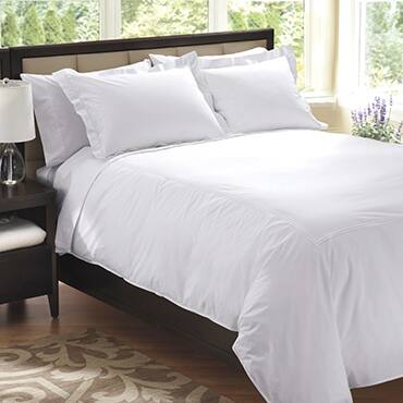 Percale sheets in white styled on bed