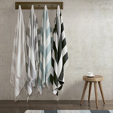 White stripped throws hanging from hooks