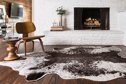 Living room with fireplace and animal hide area rug
