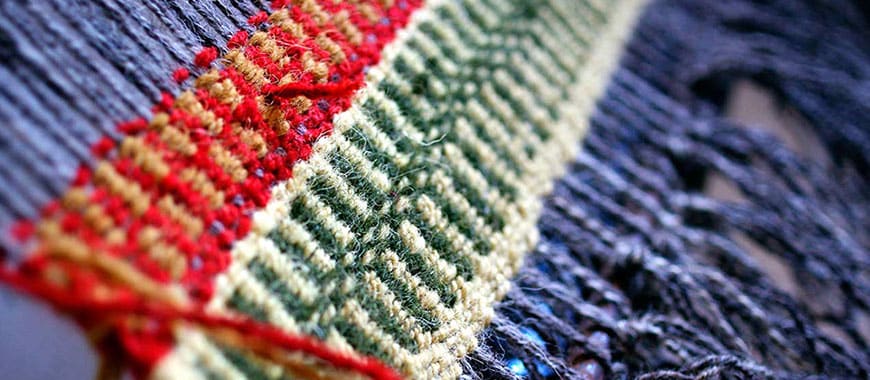Close up of a rug being woven